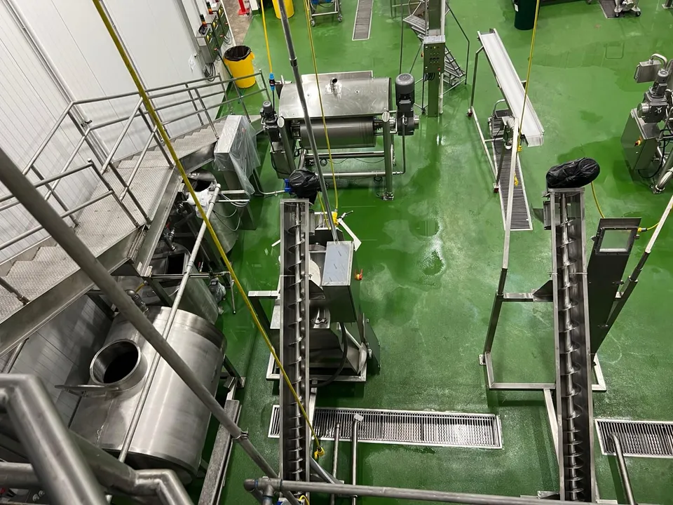Inclined screw conveyors feeding a mixer at the Northgate Markets commissary